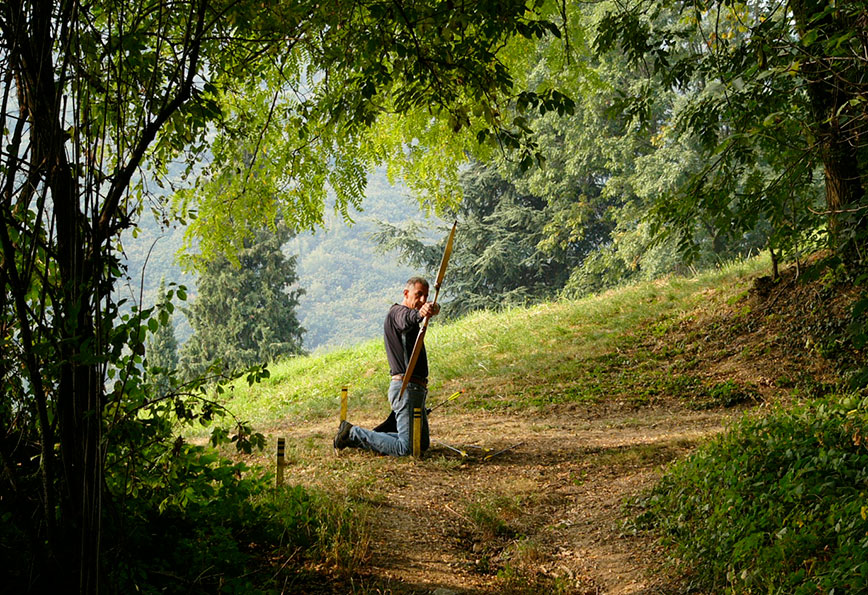 a traditional archer shooting in the wood