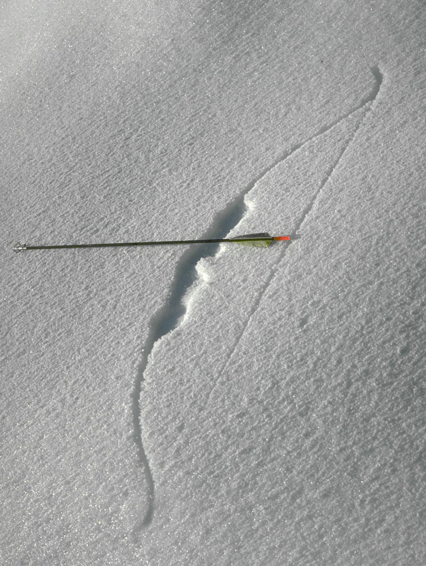 Hunting recurve bow imprint in the snow